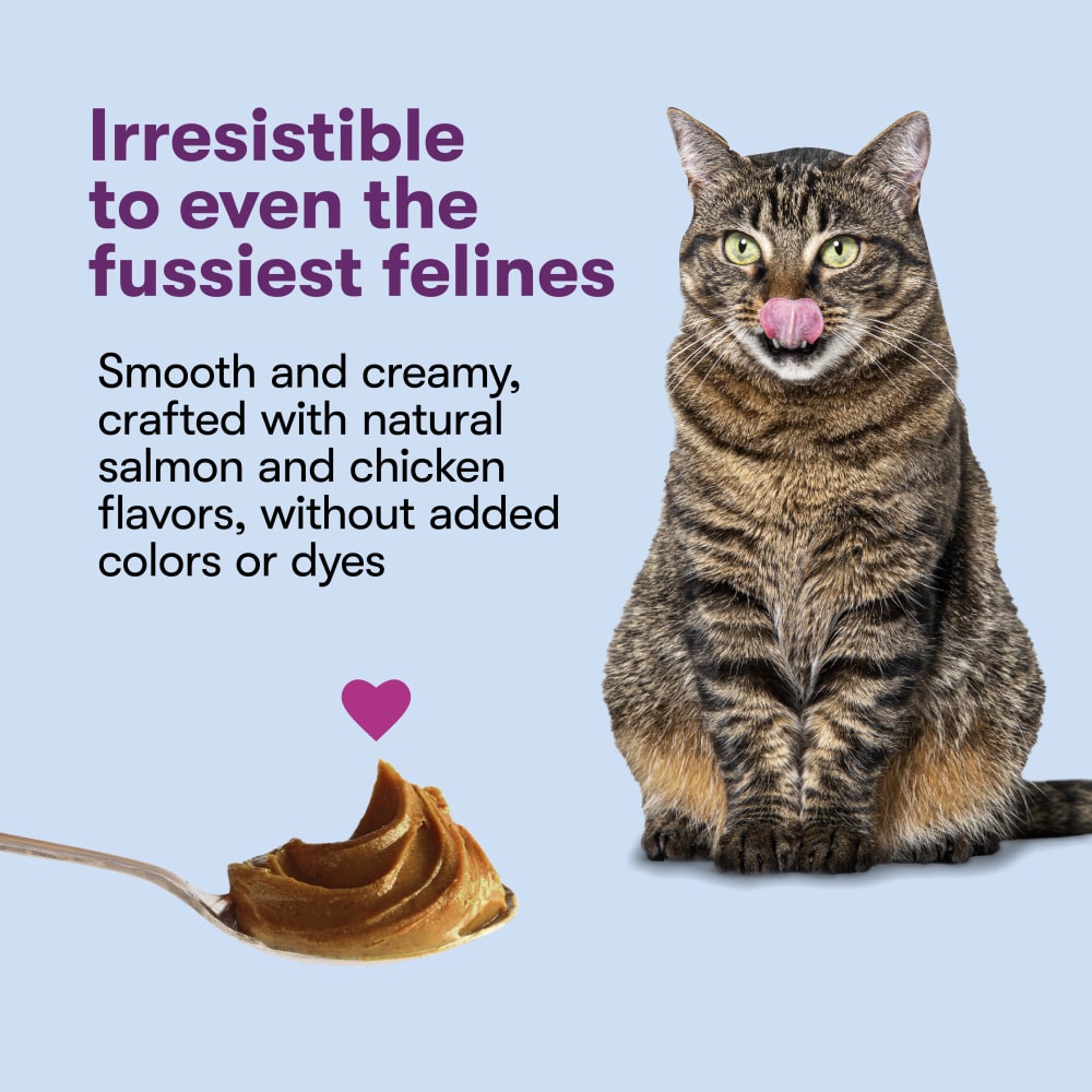 Cat licking lips beside Comfort Zone Cat Calming Mousse made with natural salmon and chicken flavors